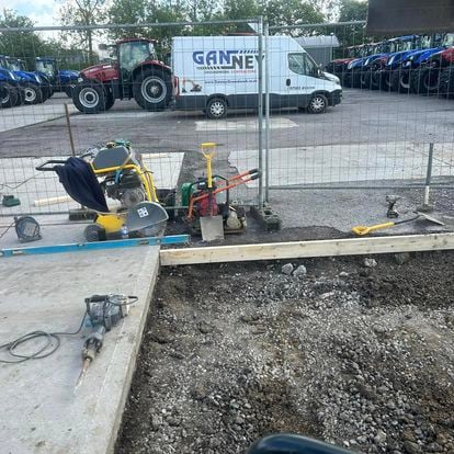 Foundation excavation with site equipment and Ganney vans in the background