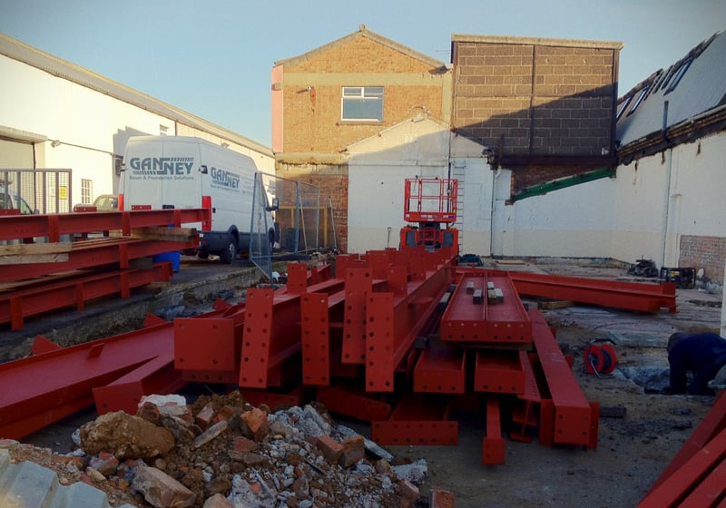 Steel beams and groundwork materials on a civil engineering site